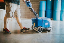 Load image into Gallery viewer, Man using automatic scrubber to clean concrete floor