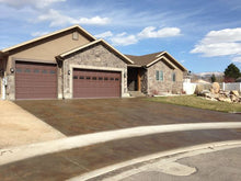 Load image into Gallery viewer, Driveway concrete stained a beautiful burnt umber color 